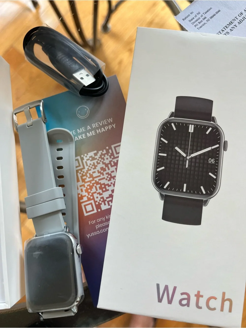 New Yussa smartwatch with a silver-tone case and a grey silicone strap.